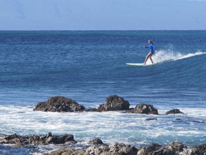 woman surfing on maui