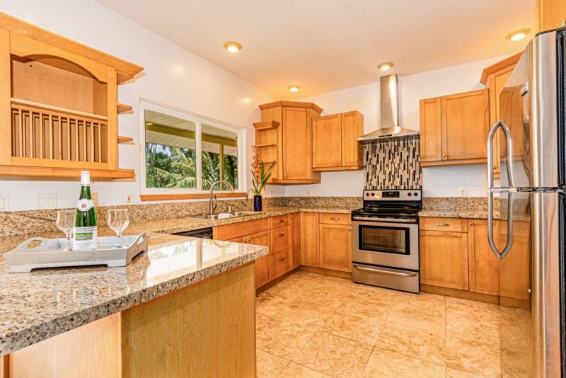 The kitchen, featuring new counters and attractive cabinets.