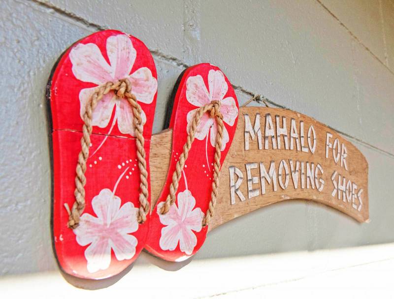sign says mahalo for removing shoes