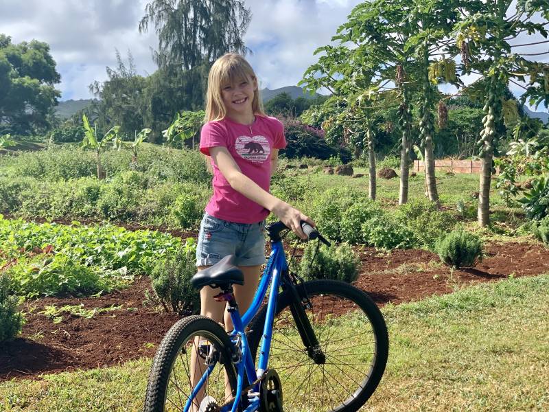 girl on bike at timbers kauai