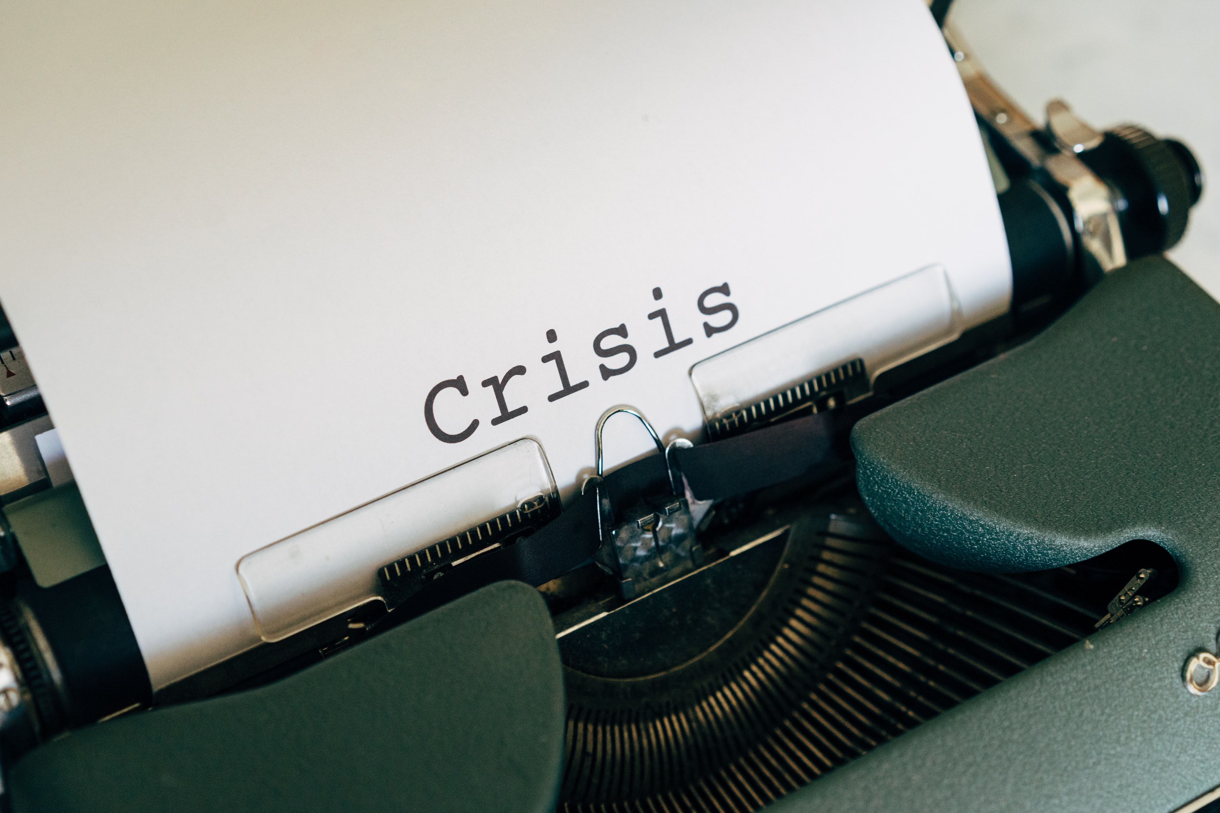 typewriter spells out crisis