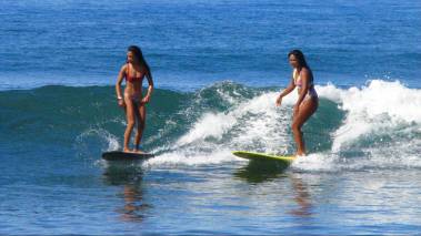 women surfing in west maui