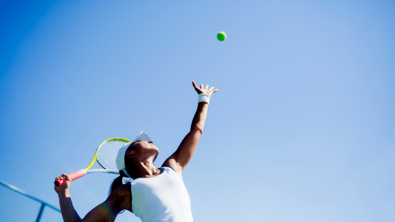 woman playing tennis at hokulia big island
