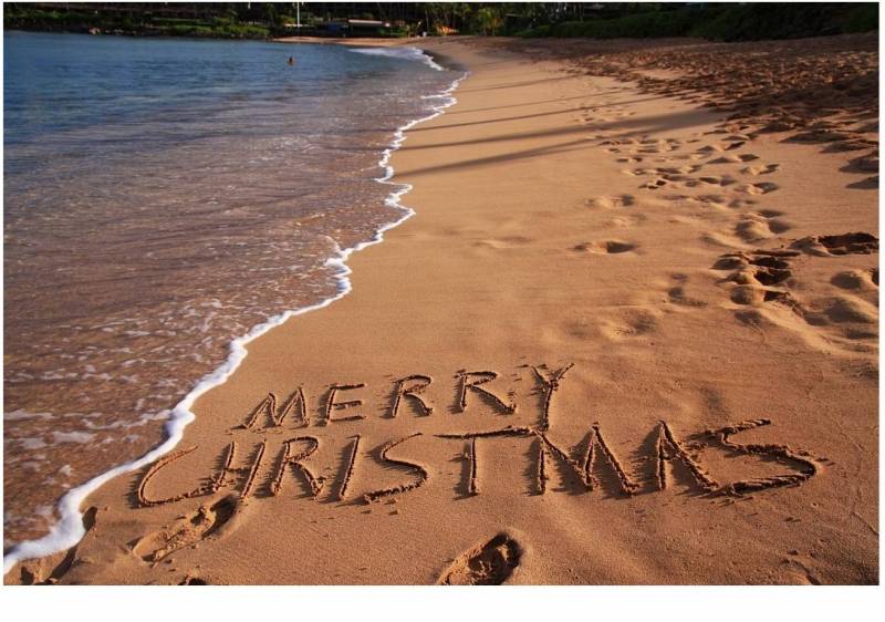 merry christmas written in the sand