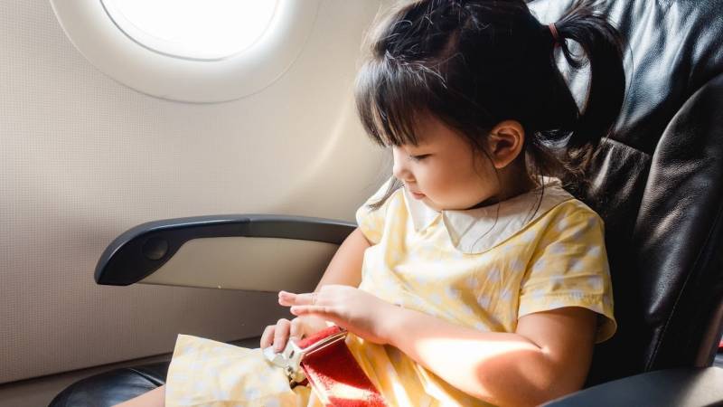 child sitting in a airplane seat