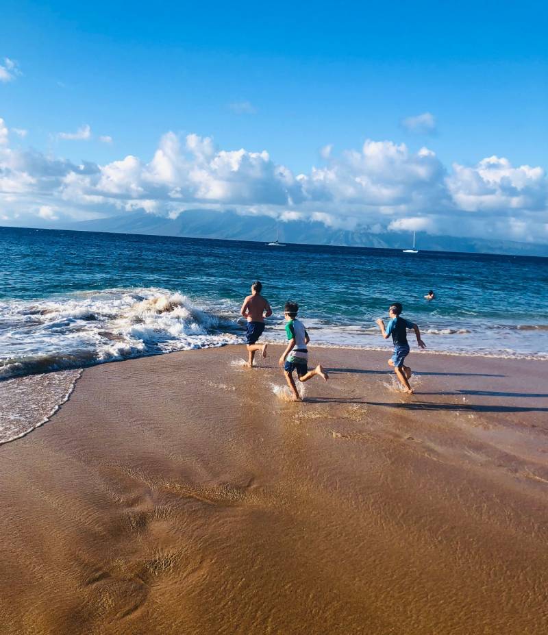 boys run on maui beach