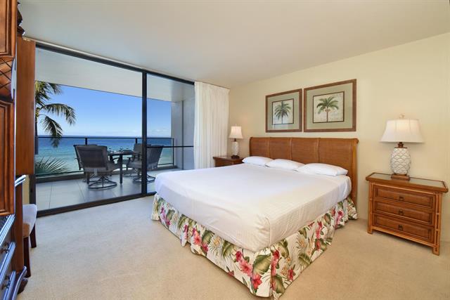 bedroom with large glass door with ocean views