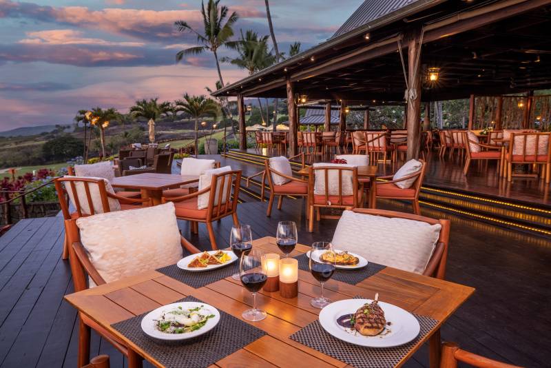 dining table with entrees at the club at hokulia at sunset