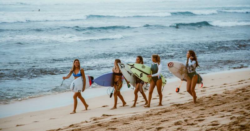Girls with surfboards on the beach