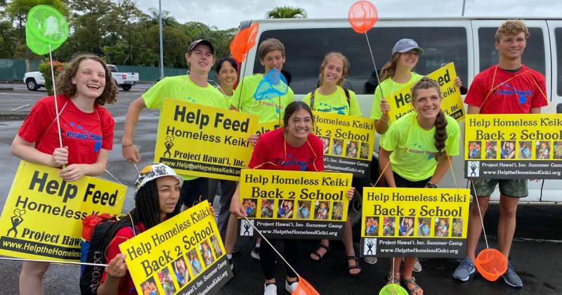 Project Hawaii volunteers with signs