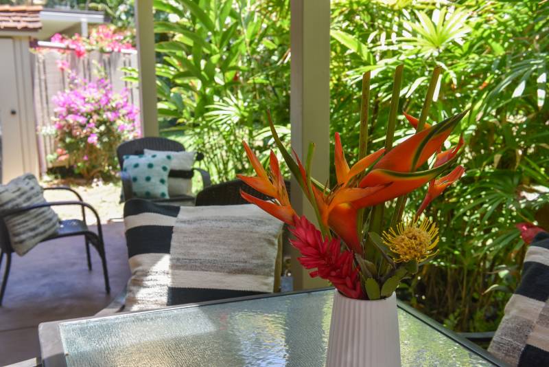 tropical flowers in a vase on outdoor table
