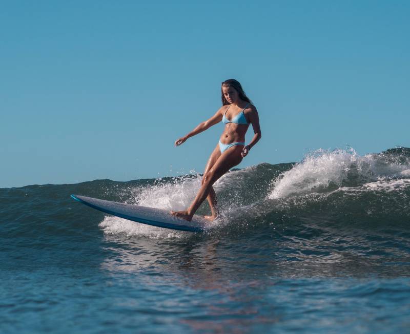 girl surfing maui waves