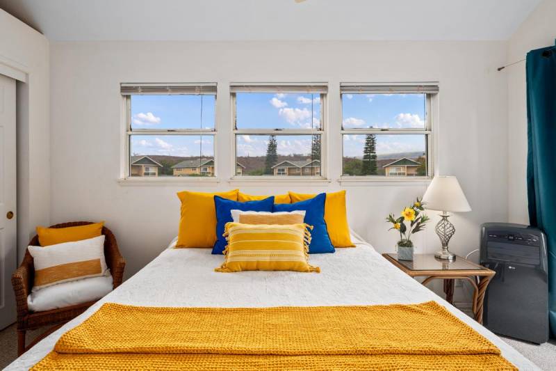 bed with yellow and blue accent pillows
