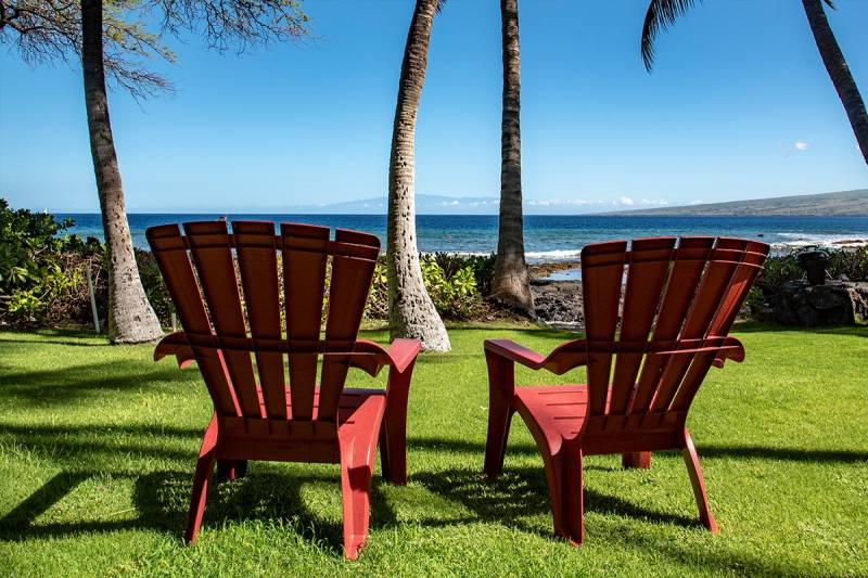 Red chairs on Puako oceanfront lawn