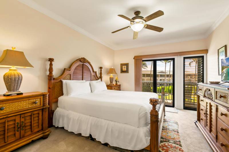 bedroom with large bed and glass door out to lanai