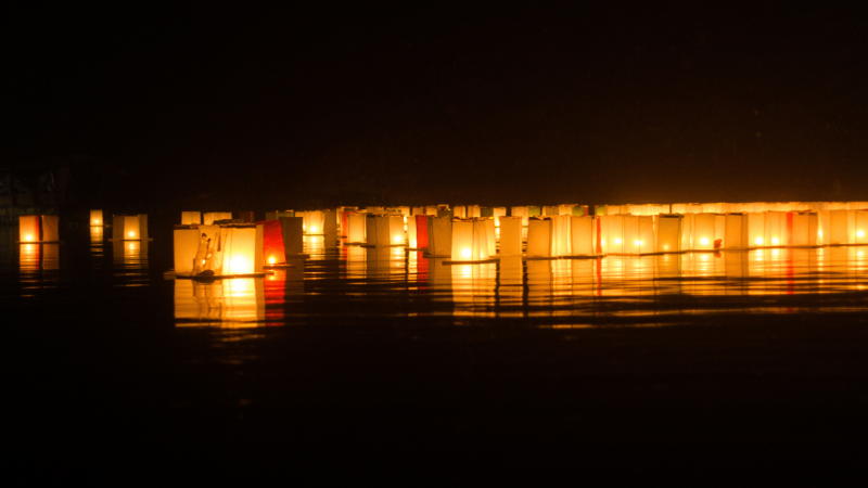 lanterns floating on water at night