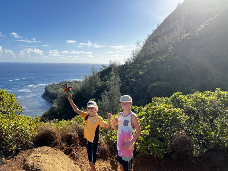 two boys hiking trail on napali coast kauai