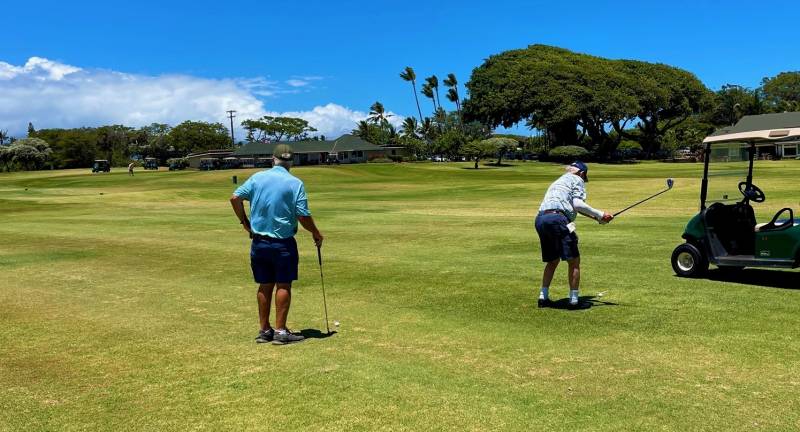 two men playing golf on maui golf course