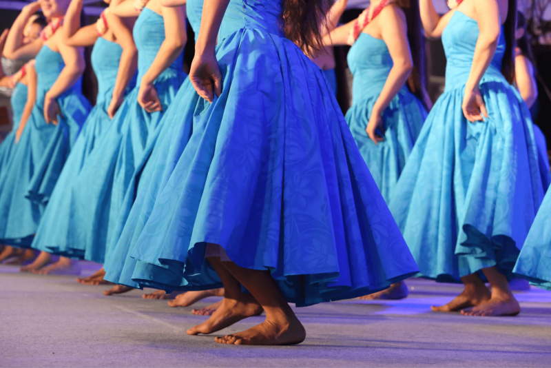 women performing hula dance in blue dresses