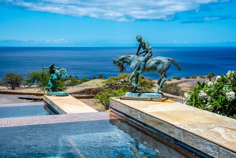 cowboy statues around pool at Kohala Ranch house for sale Big Island, Hawaii