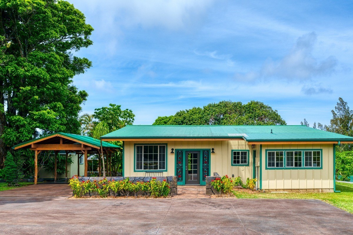 renovated home in hawi with blue-green roof and trim
