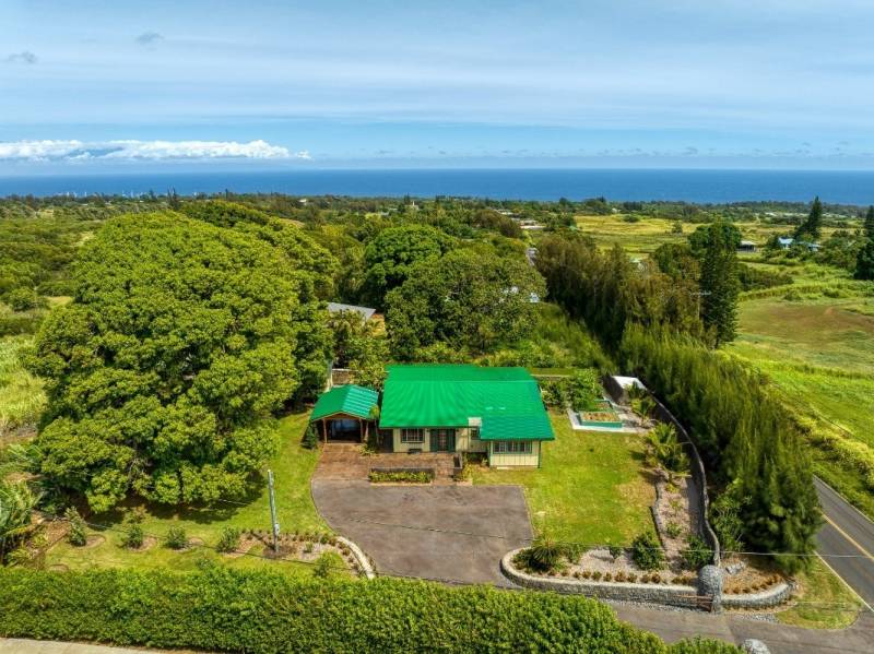 aerial view of green-roofed home in hawi surrounded by green tropical landscaping