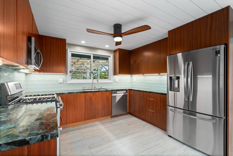 rich wood cabinets and stainless steel applianes in kitchen