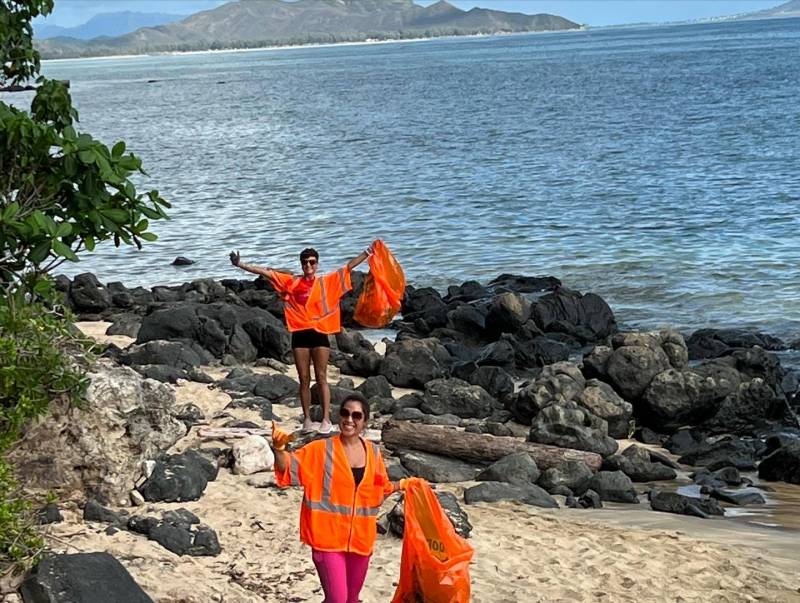 volunteers cleaning up trash on the beach