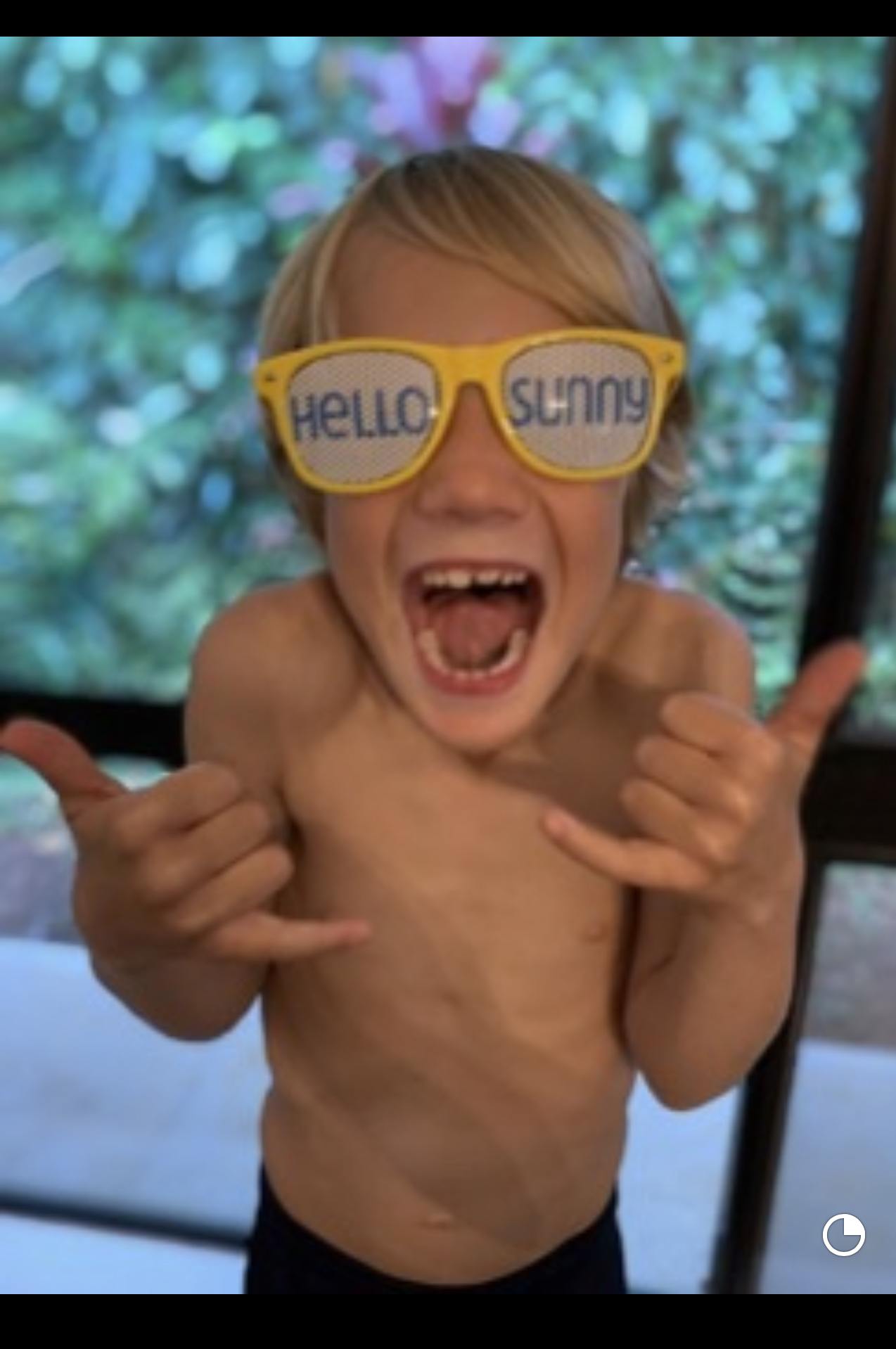 happy boy wearing yellow sunglasses