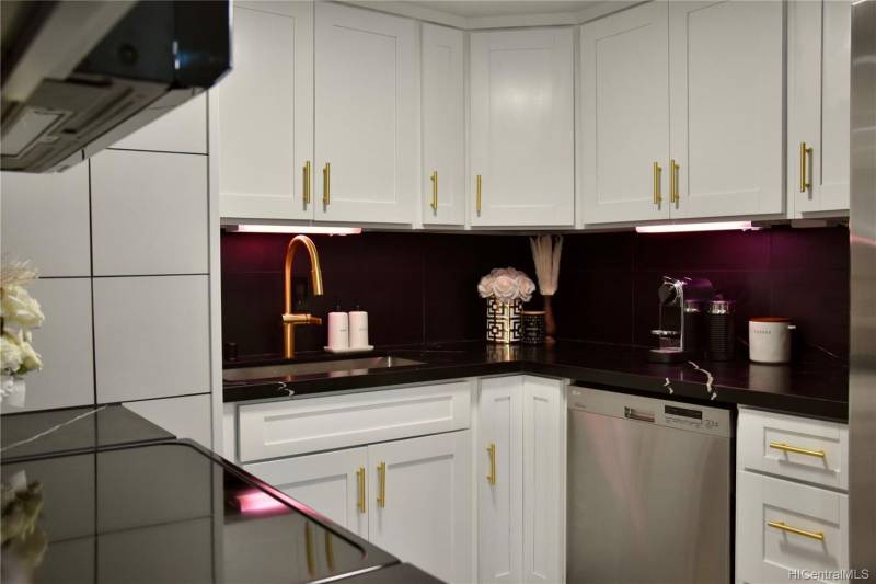 white cabinets with gold hardware in the kitchen