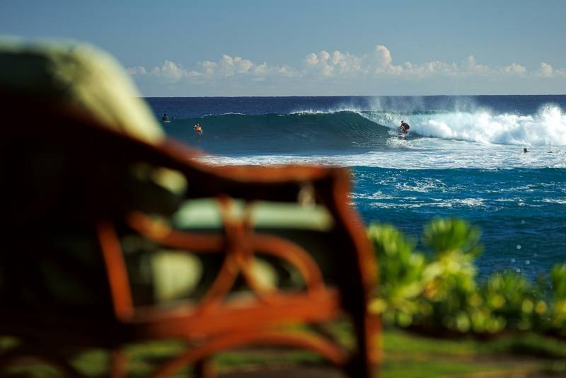 view of surfers from your backyard in this kauai home for sale