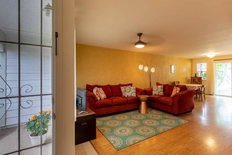 yellow wall and red sofa on warm wood floors in living room