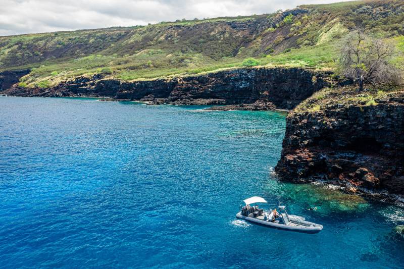 boat at sea next to pali kai land for sale on big island