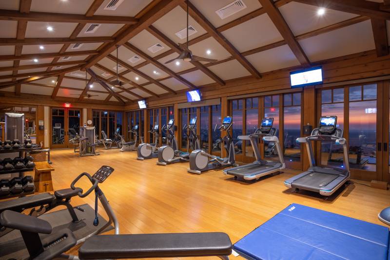 fitness center with treadmills facing the ocean