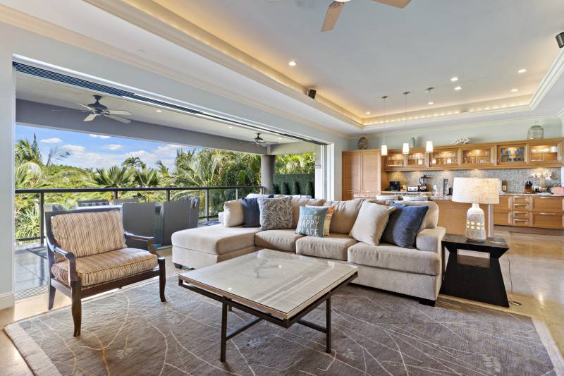 living area with wall of sliding glass doors opens to lanai