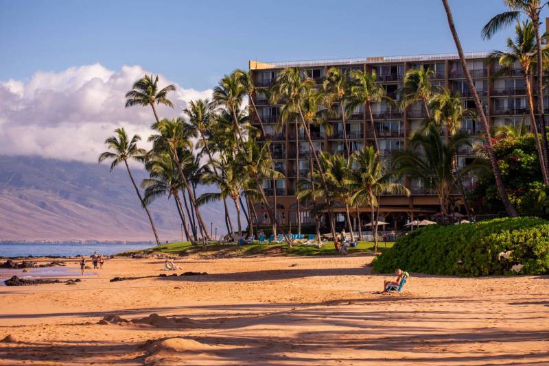 palm trees in front of condo building on maui beach