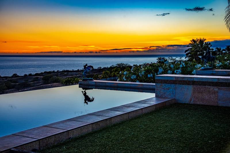 sunset over a swimming pool on hawaii island