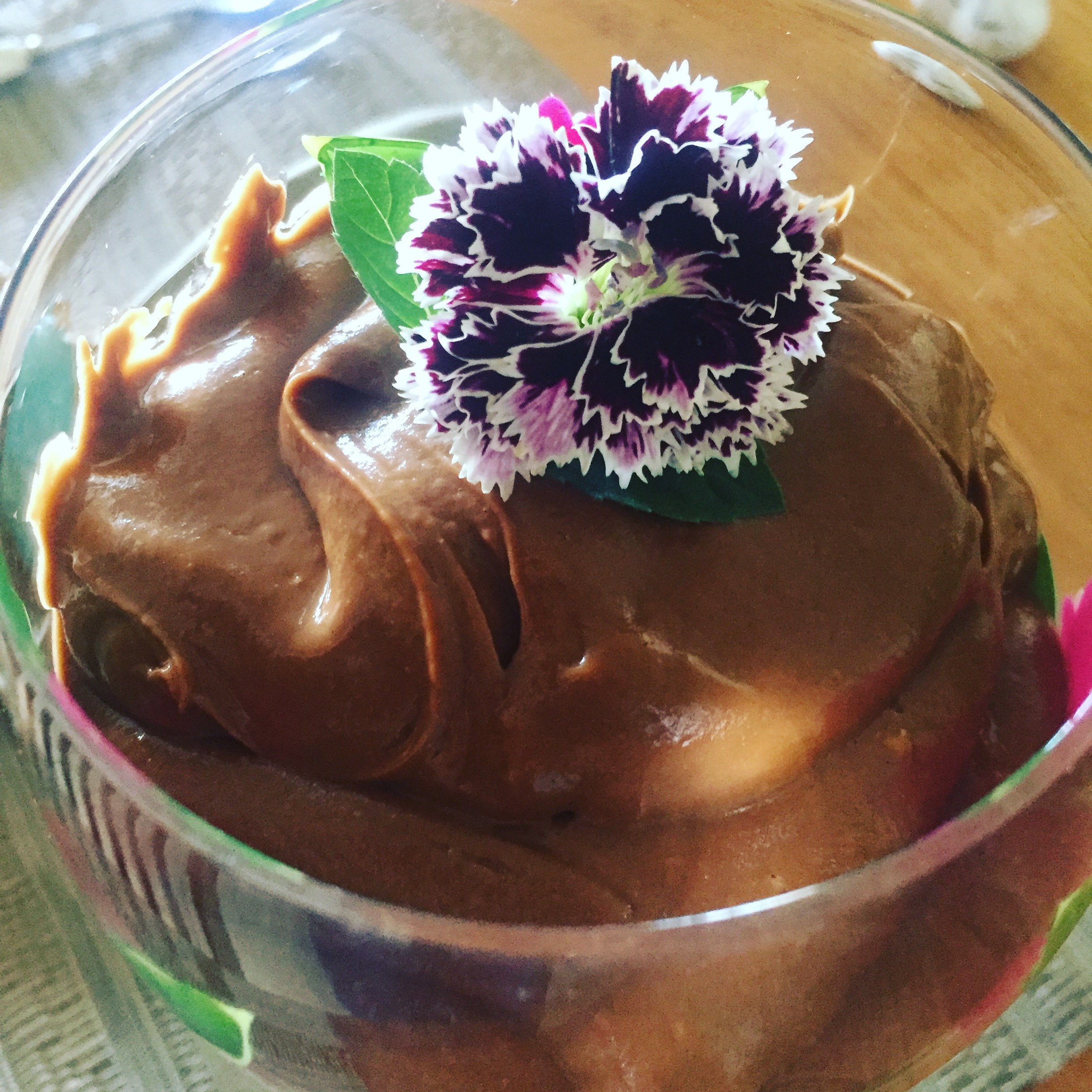 chocolate avocado pudding with dianthus flower on top