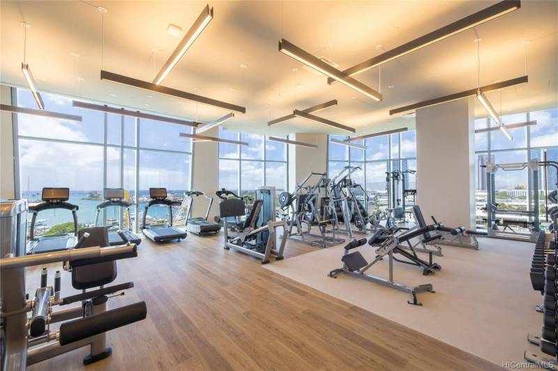 koula condo gym with lots of fitness equipment and ocean views