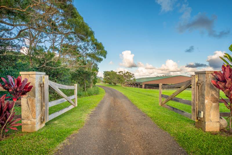 gates open with road leading to kauai north shore ranch property for sale