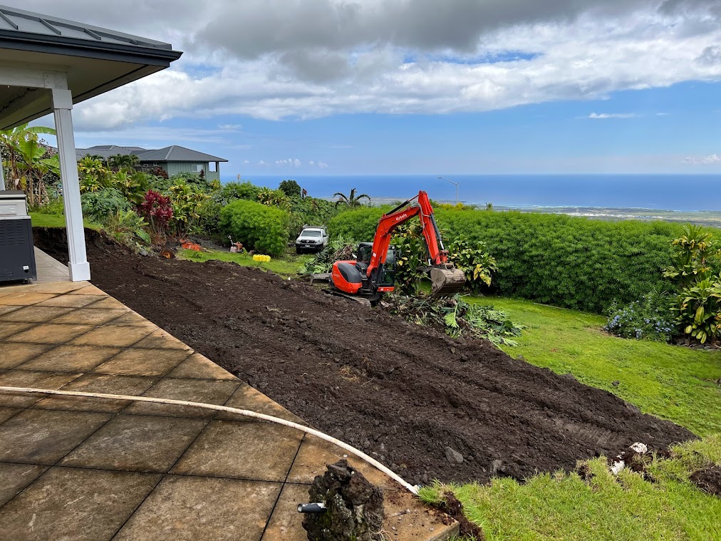 excavator digging out pool in hawaii ocean view backyard