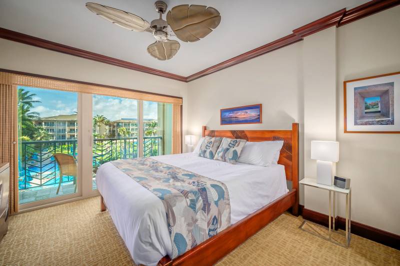 bedroom with glass doors to lanai and pool views