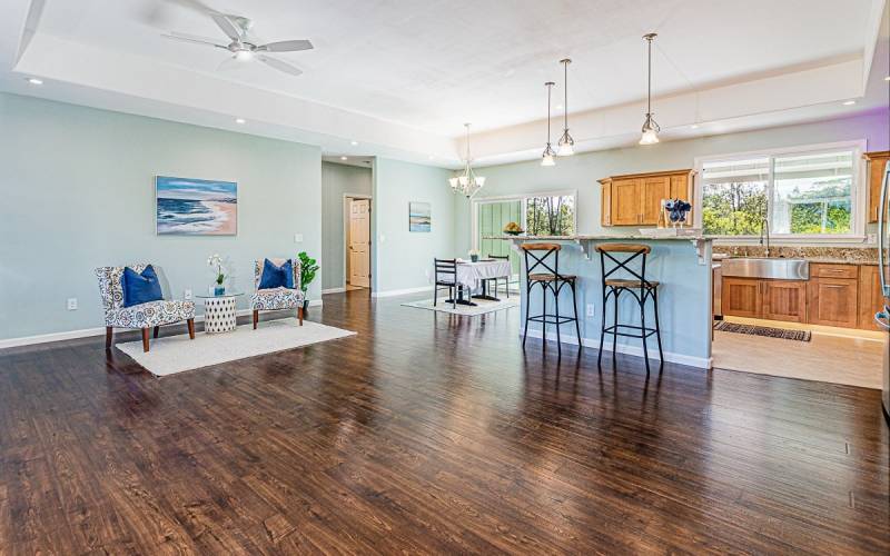 dark wood floors and high ceilings in this big island living room and kitchen great room