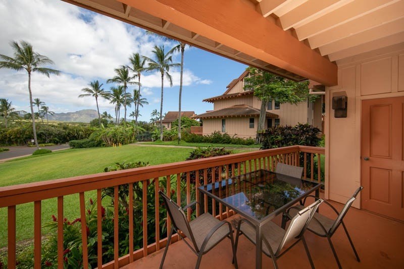 table and chairs on covered lanai with mountain views