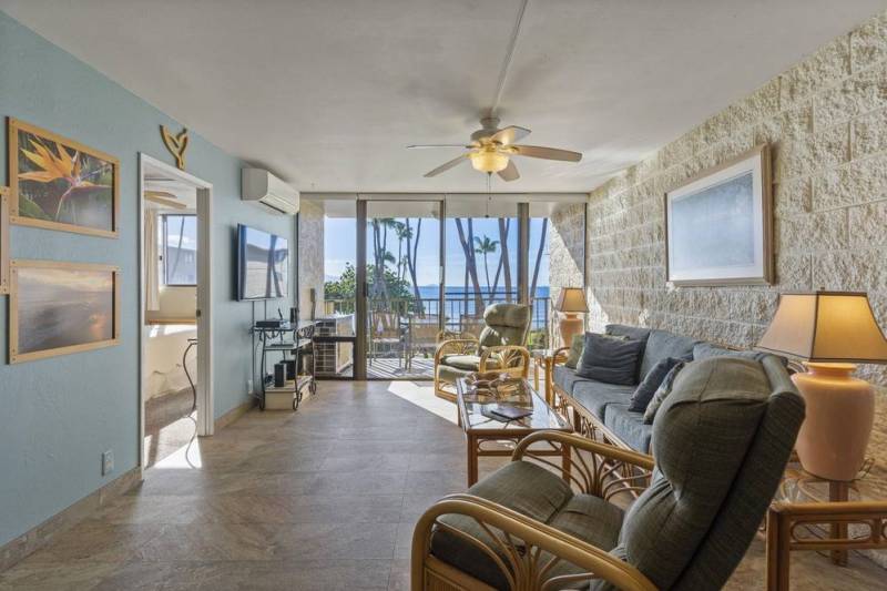 living room looking out to lanai and ocean views in Kanai A Nalu condo