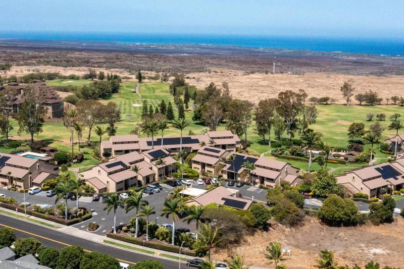 aerial view of big island condo complex with ocean in background
