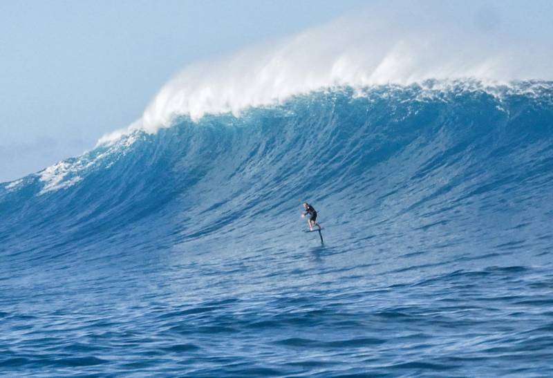 man surfing on big wave in hawaii