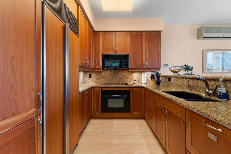 mid toned wood cabinets in kitchen