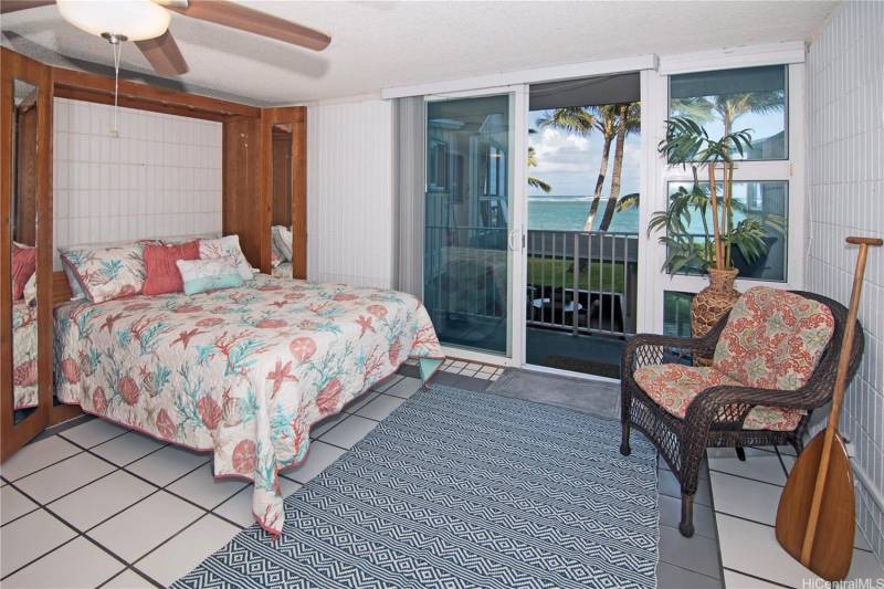 bedroom with door to lanai ocean views