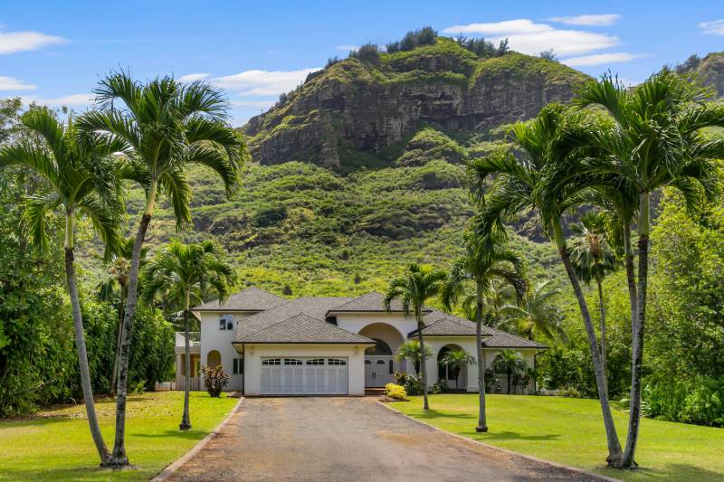 driveway leading up to home in front of mountain on kauai